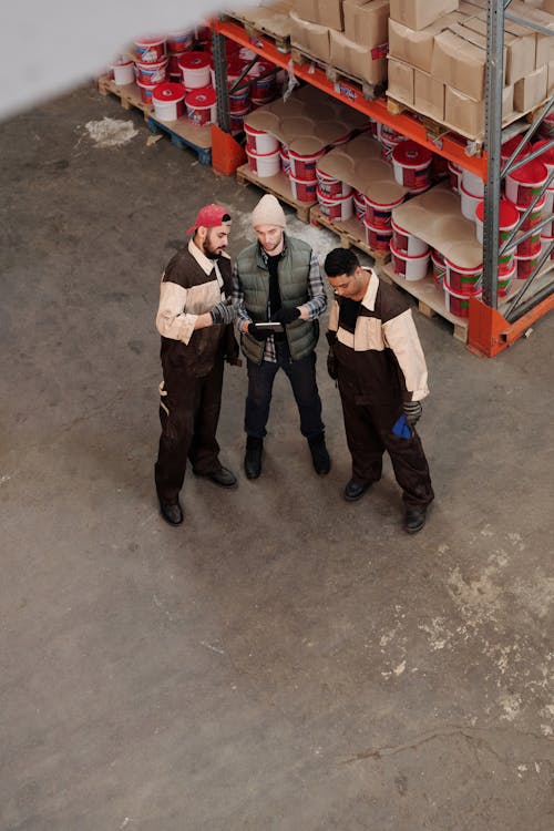 Operational team aligning active field execution requirements inside an industrial warehouse environment